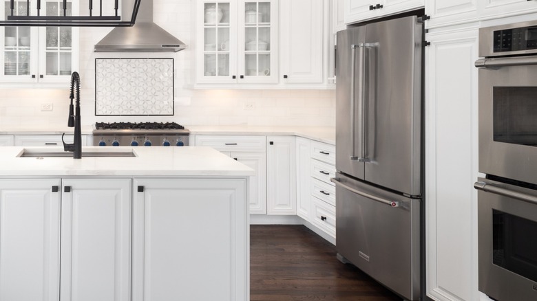 Stainless steel Thermador fridge in a white professional-looking kitchen