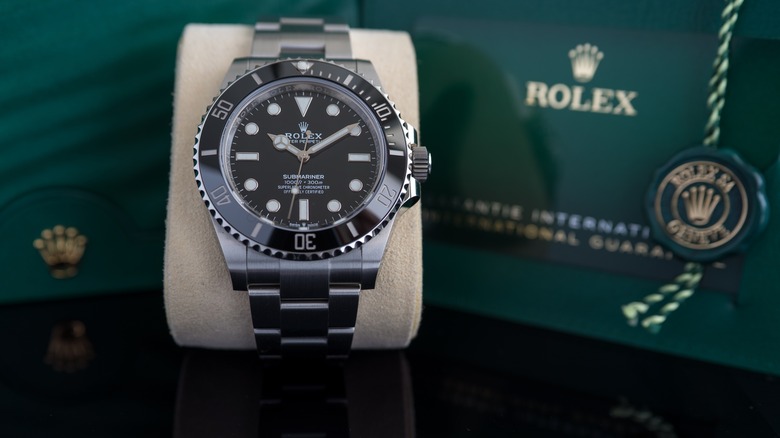 A Rolex Submariner watch with a black dial.