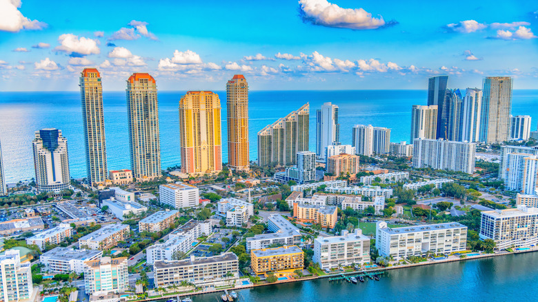 Multiple coastal hotels, resorts, and condominiums along Sunny Isles Beach in Florida.