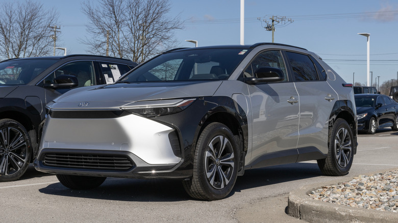 A silver Toyota bZ4X EV on display at a dealership.