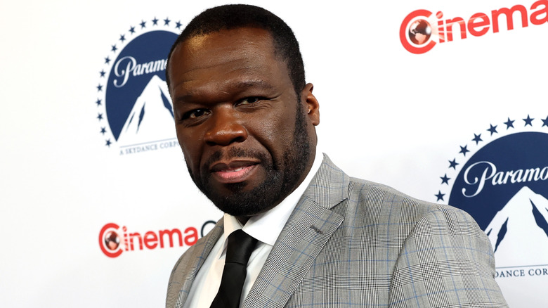 Rapper 50 Cent poses for photographs