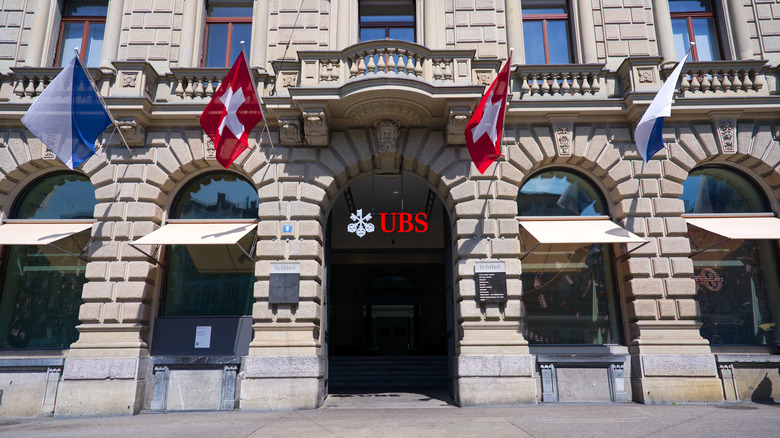 Bank building of UBS in Zürich with Swiss flags