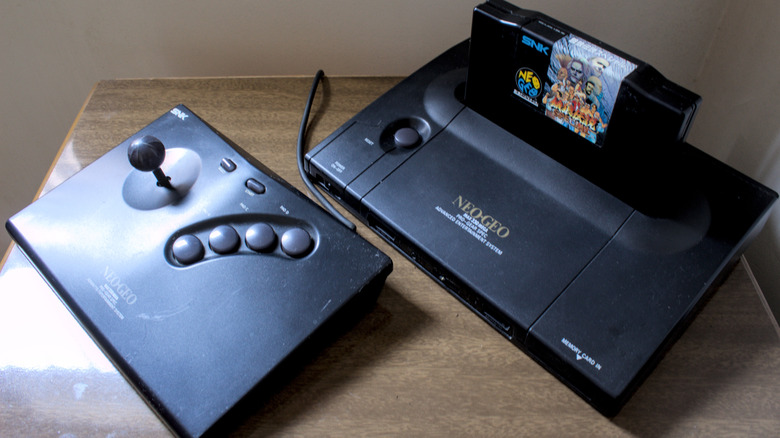 A SNK Neo Geo AES sitting on a wood table