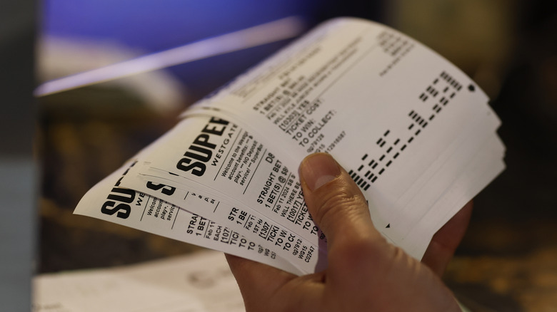 hand holdingbetting slips