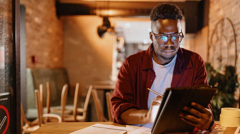 man calculating business expenses