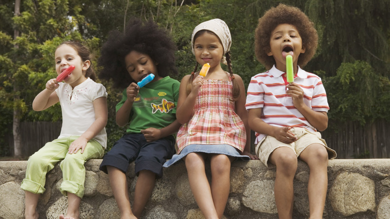 children sitting on wall