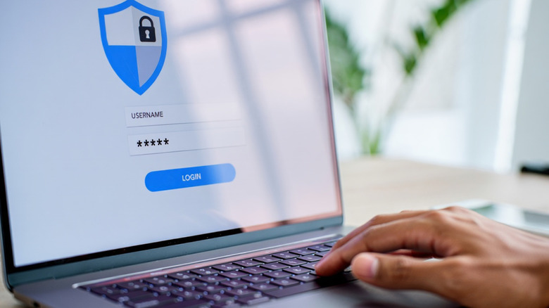 Person logging onto a website on a laptop.