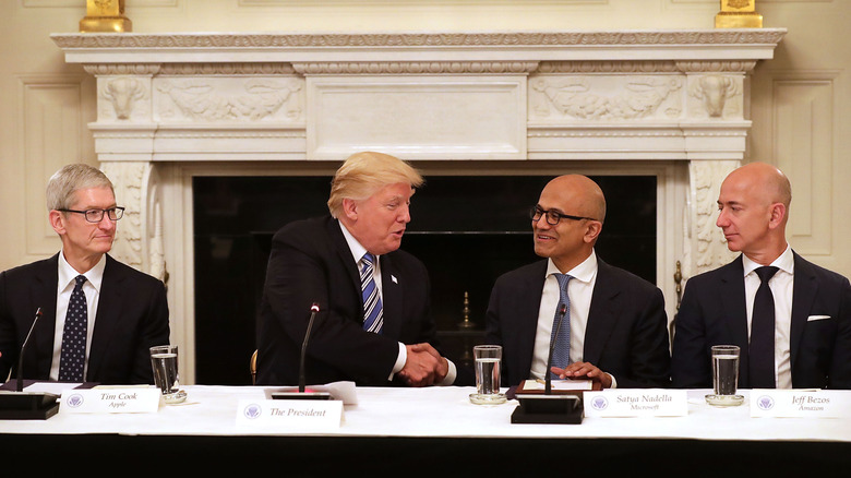 President Donald Trump with Apple CEO Tim Cook, Microsoft CEO Satya Nadella, and then-Amazon CEO Jeff Bezos in June 2017.