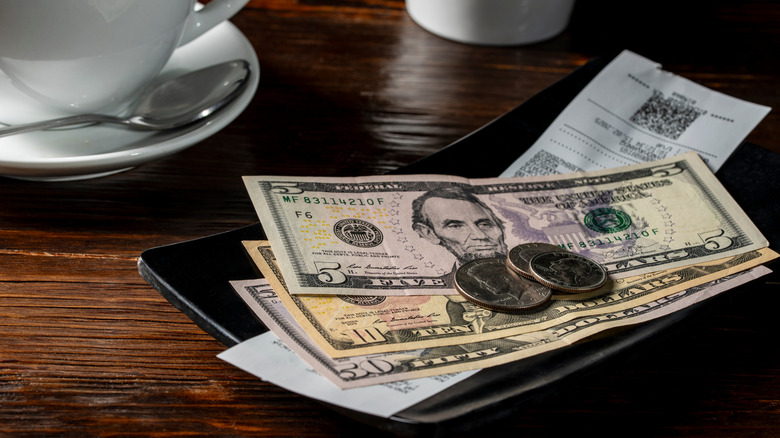 A cash tip on a tray on a table.