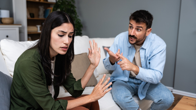 couple having an argument with woman refusing to listen