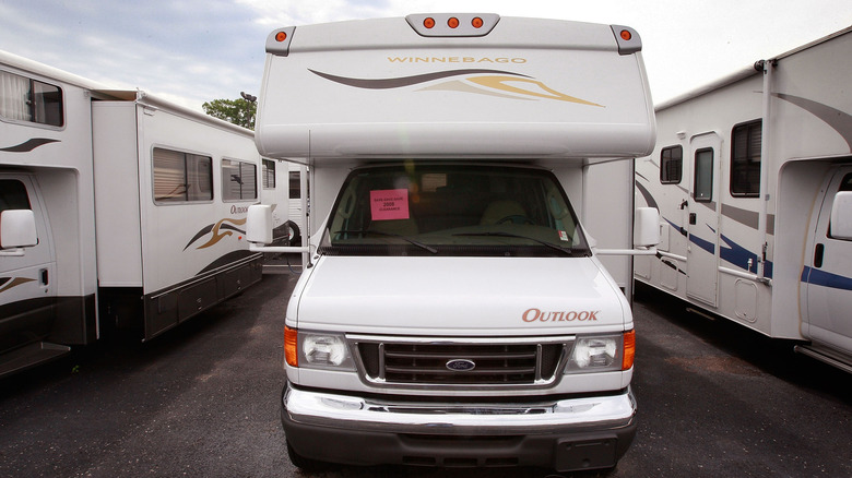 Parked RVs for sale at a dealership