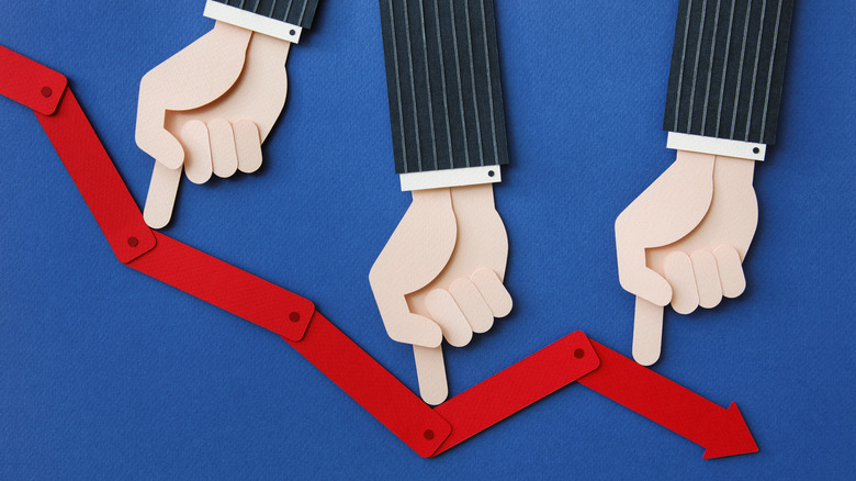 Hands pointing at downward red arrow