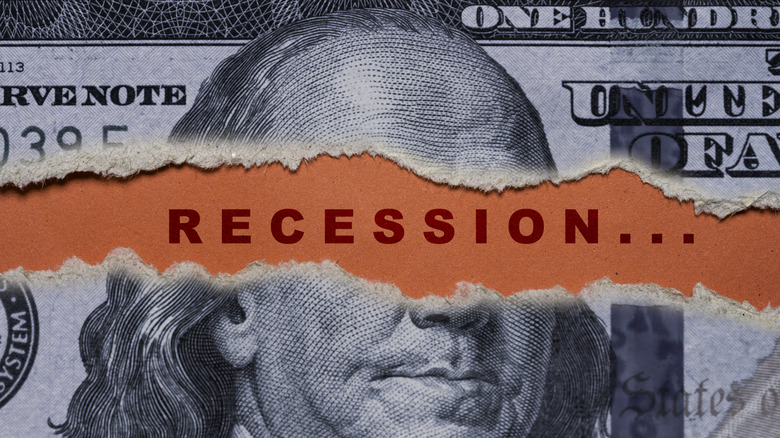 Recession spelled out in between ripped $100 bill