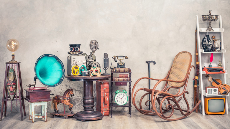A bunch of old antiques artfully arranged.