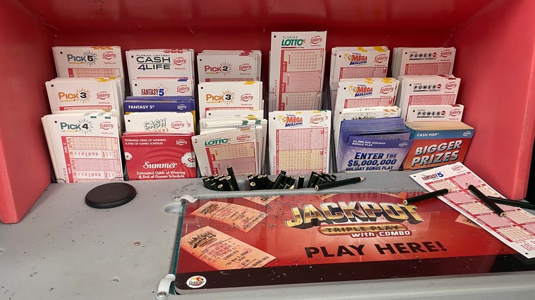 Jacksonville, Florida - December 1, 2023: A Florida lottery stand with tickets for Mega Millions, Powerball and other Florida lottery tickets at a gas station.