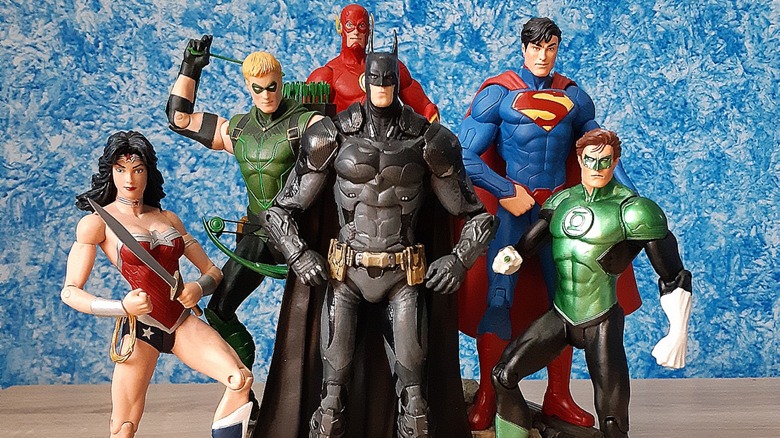 Six posed toy figures based on DC comic heroes with Batman in the foreground.