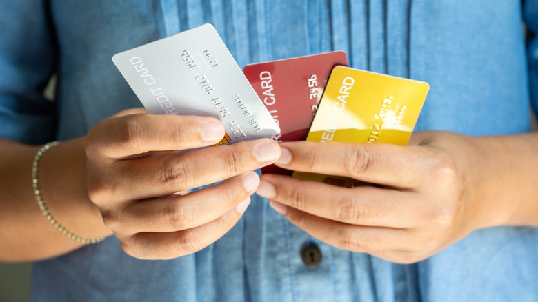 Picture of woman holding three credit cards