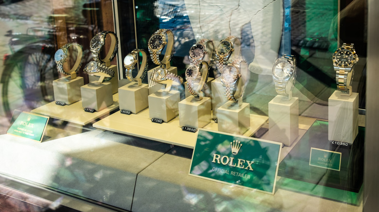 Array of rolex watches on display inside a glass case