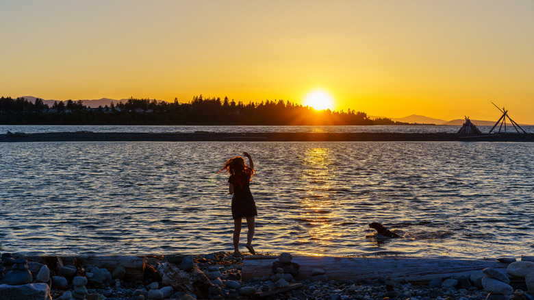 Girl and a dog on the beach near Parksville, British Columbia
