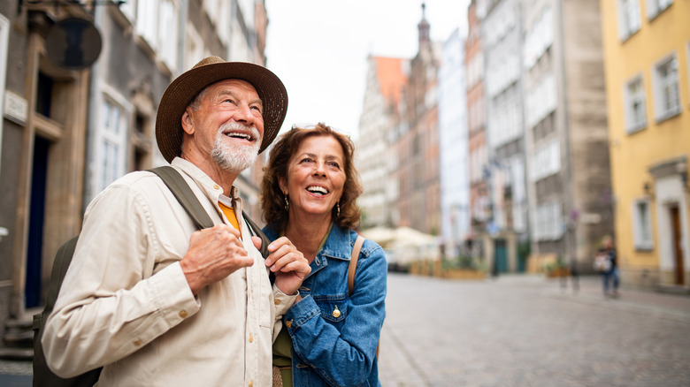 Elderly couple traveling in a city