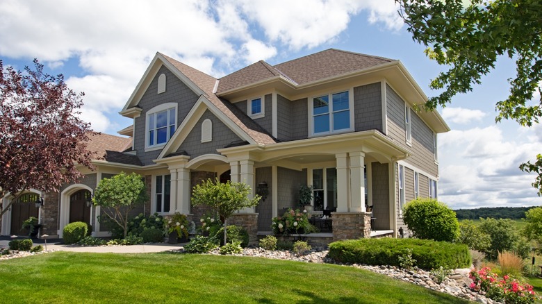 A large house with a nice lawn in a wealthy American suburb.