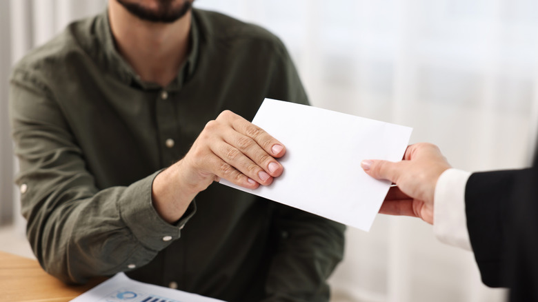 Young man receiving a paycheck