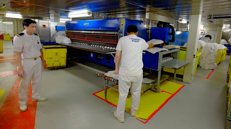 A laundry cruise crew staff at work on a cruise ship