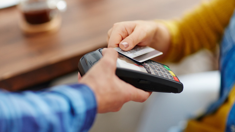 Person using card to make purchase.