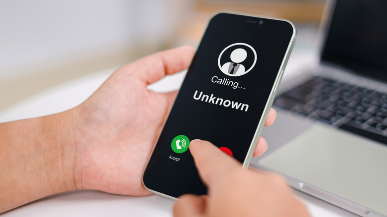 Woman receives a phone call from an unknown number.