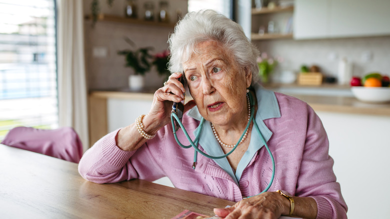 A elderly woman making a call