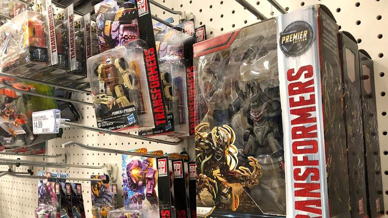 Transformer toys hanging in boxes on shelves