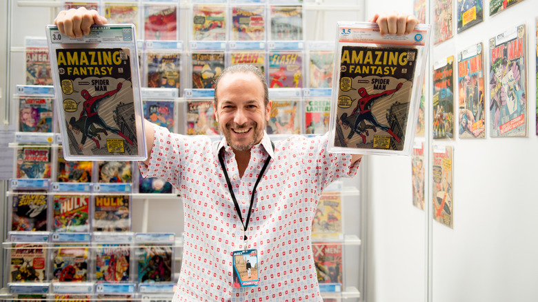 Comic collector holds up two copies of Amazing Fantasy 15