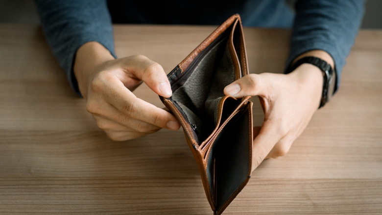 Hands holding an empty wallet