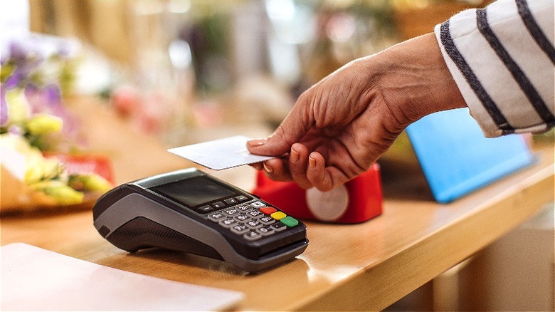 Holding credit card over terminal