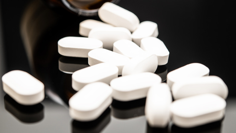 White pills on a black surface
