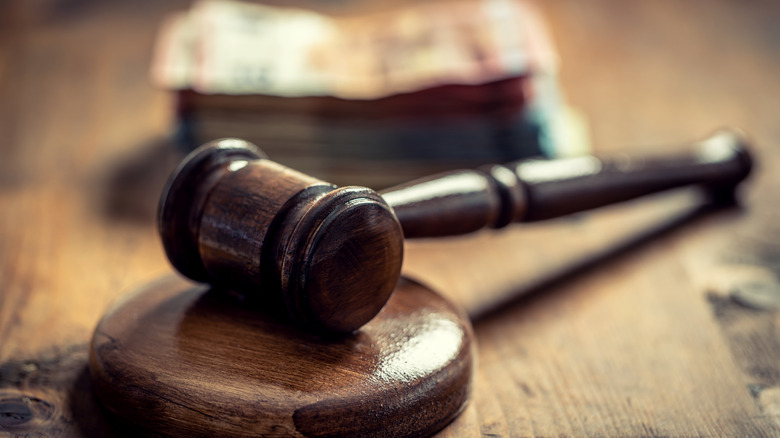 gavel and stack of money in background
