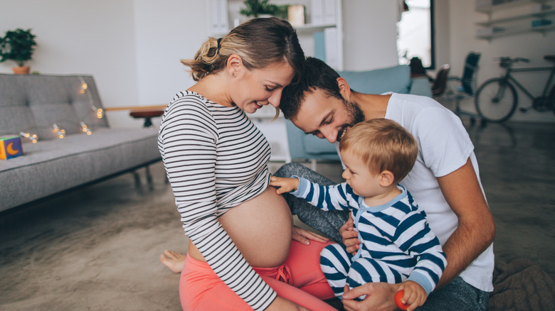 Little boy being curious about his mother's growing belly