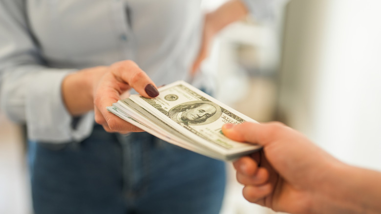 Person handing over cash.