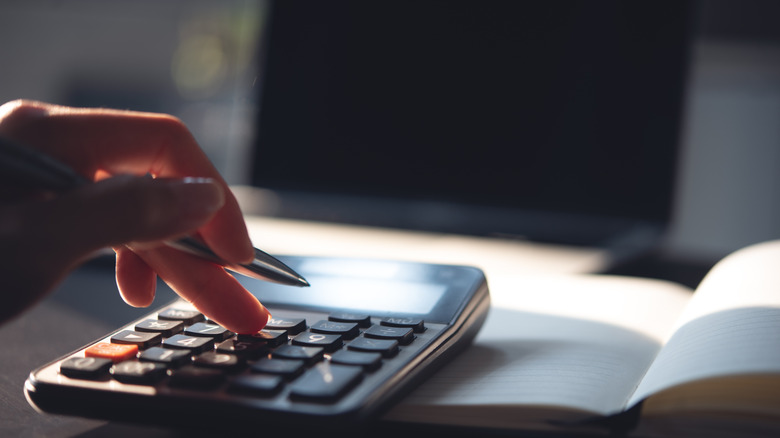 A person using a calculator
