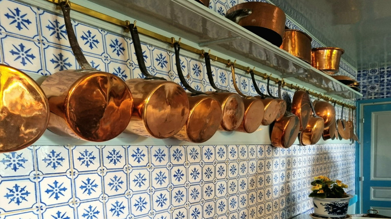 Line of vintage copper pots