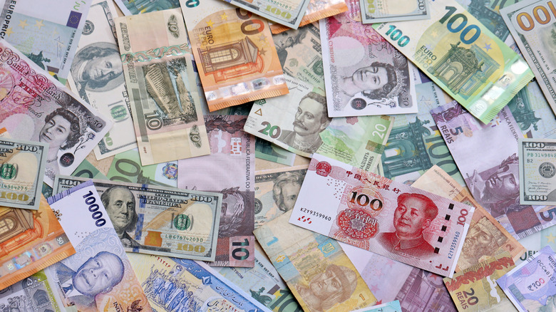 Different kinds of currency bank notes in a pile