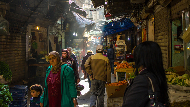 People walk through the narrow alley of a covered souk in Tripoli, Lebanon