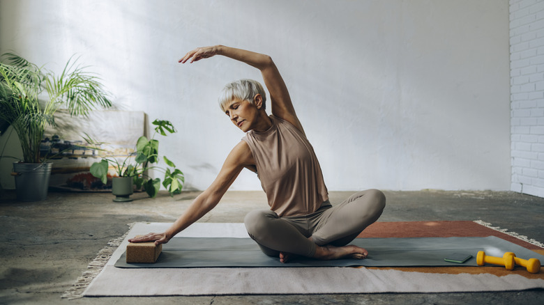 Woman stretching on yoga mat