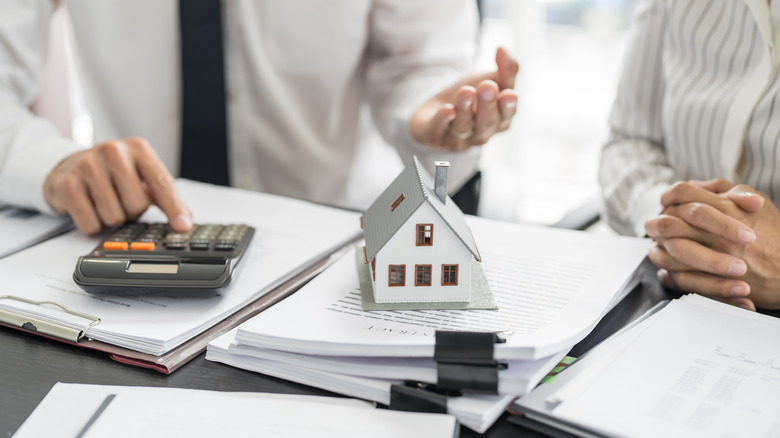 people looking over real estate purchase documents