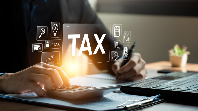 tax superimposed over laptop and calculator