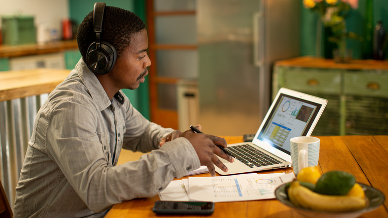 a young investor looking at charts on computer