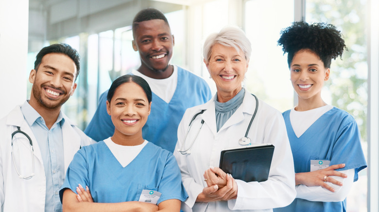 A diverse group of smiling medical professionals at a hospital or private clinic.