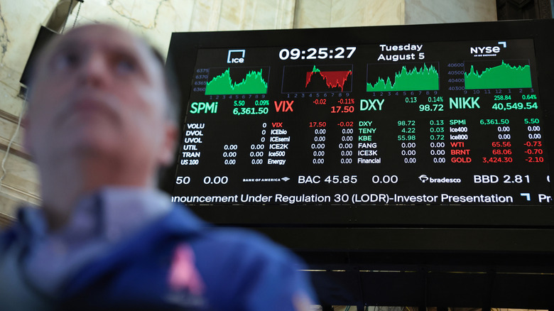 Stock market numbers are displayed as traders work on the floor of the New York Stock Exchange.