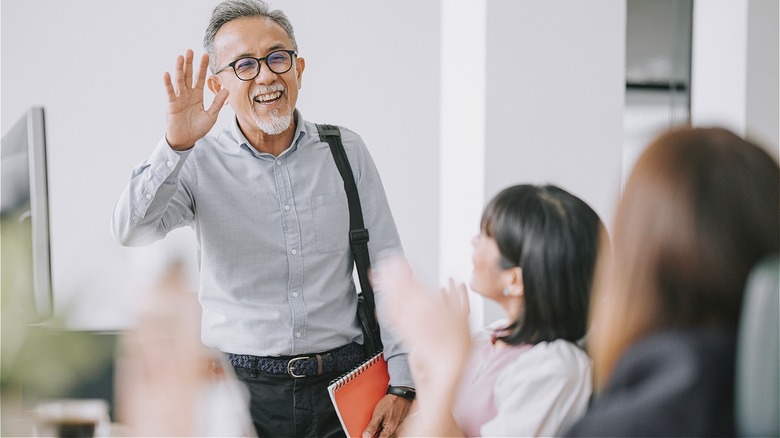Person waving at work coworkers