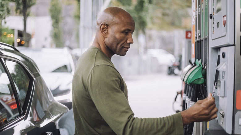 Man paying for gas at the pump with credit card
